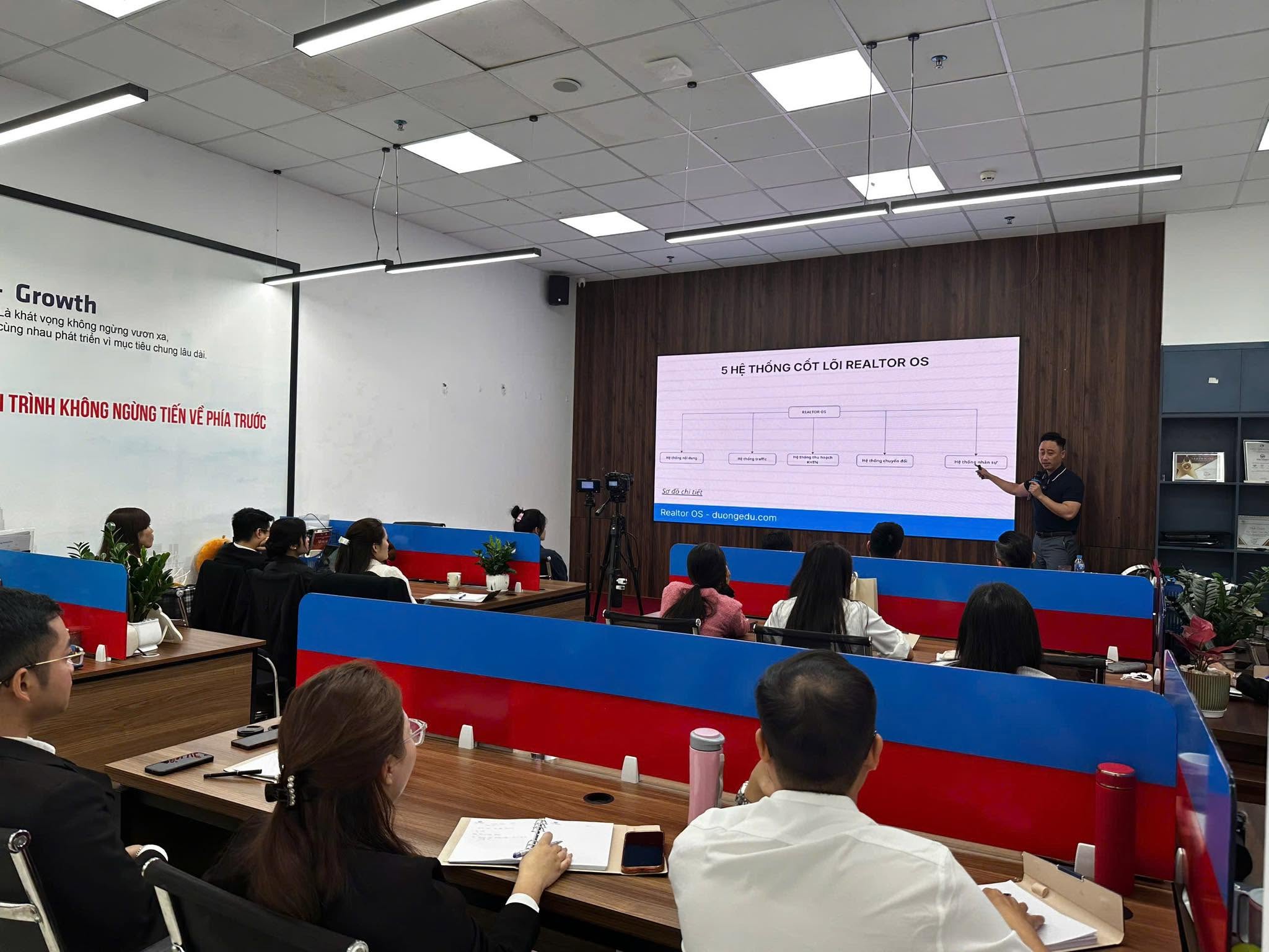 Đăng Dương cầm micro giảng về 5 hệ thống cốt lõi Realtor OS trước học viên trong lớp đào tạo môi giới bất động sản